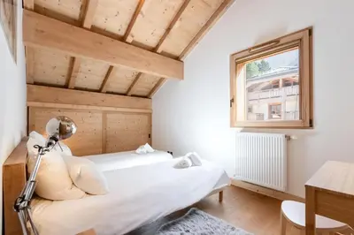 a bedroom with two beds and a window at Terra Losa 2 - Quiet and modern apartment - City center in Les Houches