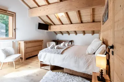 a bedroom with a bed and a wooden ceiling at Terra Losa 2 - Quiet and modern apartment - City center in Les Houches