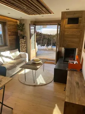 a living room with a couch and a table at Appartement centre megeve in Megève