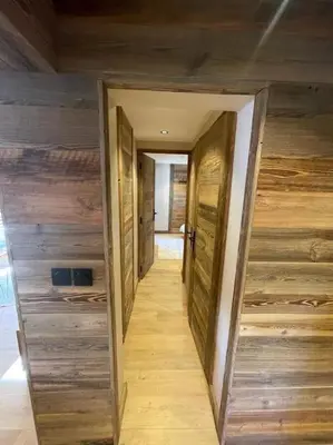 a hallway in a house with wooden walls at Appartement centre megeve in Megève