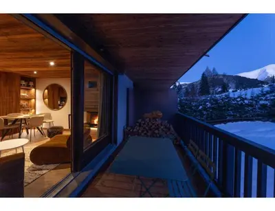 a balcony of a house with a view of the mountains at Modern 2 bedroom apartment, close to ski lifts in Megève