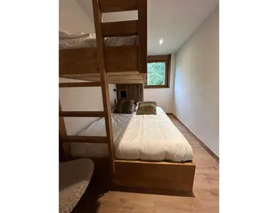 a bedroom with a bunk bed with a ladder at Modern 2 bedroom apartment, close to ski lifts in Megève