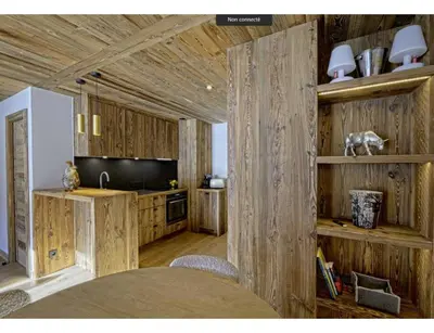 a kitchen with wooden walls and a table with chairs at Modern 2 bedroom apartment, close to ski lifts in Megève