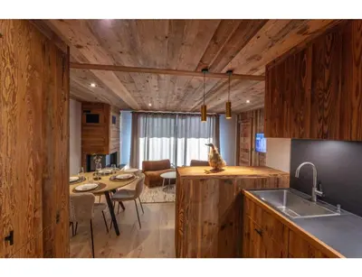 a kitchen with a table and a dining room at Modern 2 bedroom apartment, close to ski lifts in Megève