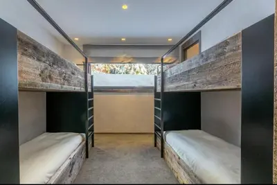 two bunk beds in a room with a window at Chalet Esquinade 4 bedrooms appartment Megève in Megève
