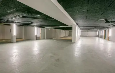 an empty room of an empty building with a concrete floor at Chalet Esquinade 4 bedrooms appartment Megève in Megève