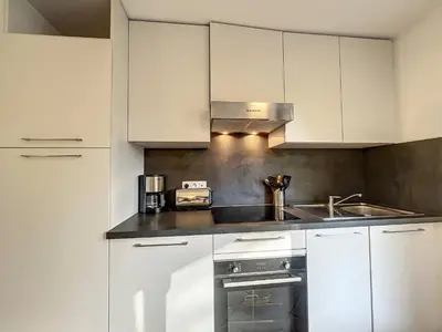 a kitchen with white cabinets and a sink at Appartement au centre de Chamonix - 6 pers, parking, confort 3 étoiles - FR-1-507-74 in Chamonix-Mont-Blanc
