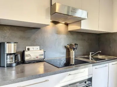 a kitchen with a sink and a counter top at Appartement au centre de Chamonix - 6 pers, parking, confort 3 étoiles - FR-1-507-74 in Chamonix-Mont-Blanc