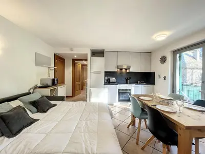 a bedroom with a large bed and a dining table at Appartement au centre de Chamonix - 6 pers, parking, confort 3 étoiles - FR-1-507-74 in Chamonix-Mont-Blanc