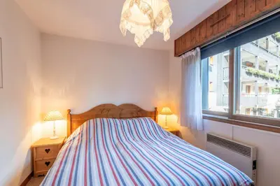 a bedroom with a bed and a window at SmartStay Mummery - Chamonix in Chamonix-Mont-Blanc