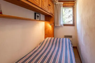 a bed in a small room with a window at SmartStay Mummery - Chamonix in Chamonix-Mont-Blanc