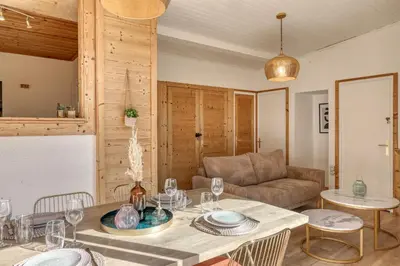 a living room with a table and a couch at chalet Relax située a 25km de Chamonix in Saint-Gervais-les-Bains