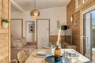 a living room with a table and a couch at chalet Relax située a 25km de Chamonix in Saint-Gervais-les-Bains