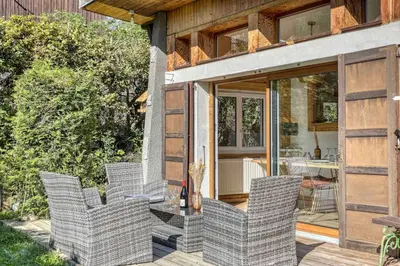 a group of chairs sitting on a patio at chalet Relax située a 25km de Chamonix in Saint-Gervais-les-Bains