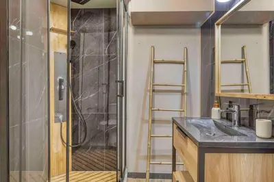 a bathroom with a shower with a sink and a glass shower door at Appartement «Chez Paulette»situé à 25Km chamonix  in Saint-Gervais-les-Bains