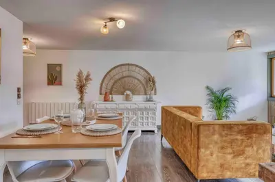 a dining room with a wooden table and chairs at Appartement «Chez Paulette»situé à 25Km chamonix  in Saint-Gervais-les-Bains