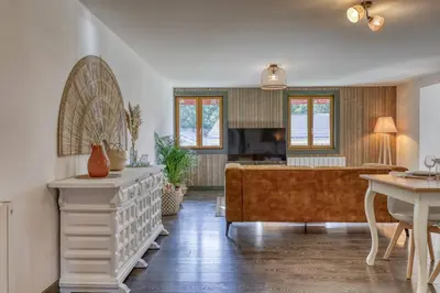a living room with a couch and a table at Appartement «Chez Paulette»situé à 25Km chamonix  in Saint-Gervais-les-Bains