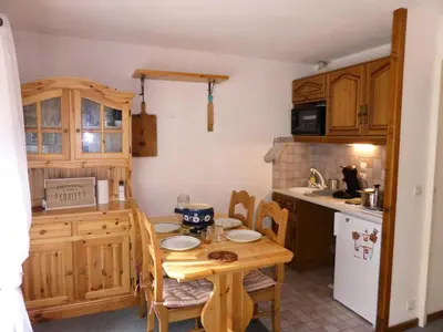a kitchen with a wooden table and a small table and chairs at Résidence Les Trolles - Trolles 5A MAE-7374 in Les Contamines-Montjoie