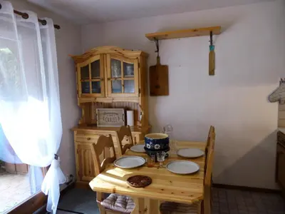 a wooden table and chairs in a room with a table and a table at Résidence Les Trolles - Trolles 5A MAE-7374 in Les Contamines-Montjoie