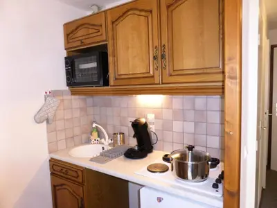 a kitchen with a sink and a stove with a pot at Résidence Les Trolles - Trolles 5A MAE-7374 in Les Contamines-Montjoie