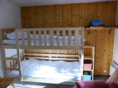 a bunk bed in a room with a wooden wall at Résidence Les Trolles - Trolles 5A MAE-7374 in Les Contamines-Montjoie