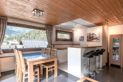 a kitchen with a table and a view of a mountain at Les Marmottes - Renovated and cozy apart - View of the mountains in Les Houches