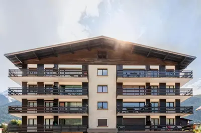 a building with balconies on the side of it at Les Marmottes - Renovated and cozy apart - View of the mountains in Les Houches