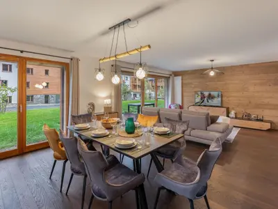 a dining room and living room with a table and chairs at Appartement moderne 3 chambres à Megève avec garage - FR-1-569-131 in Megève