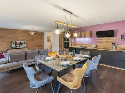 a dining room and living room with a table and chairs at Appartement moderne 3 chambres à Megève avec garage - FR-1-569-131 in Megève