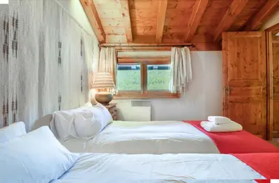 a bedroom with two beds and a window in it at Amethyste - 2 Bedrooms & Free Parking - By Cozee Rentals in Les Houches