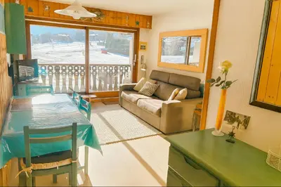 a living room with a couch and a table at Family Apartment Mont Blanc View in Chamonix-Mont-Blanc