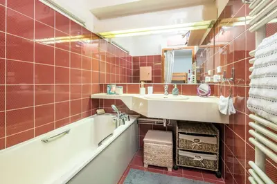 a bathroom with a sink and a tub and a mirror at Family Apartment Mont Blanc View in Chamonix-Mont-Blanc
