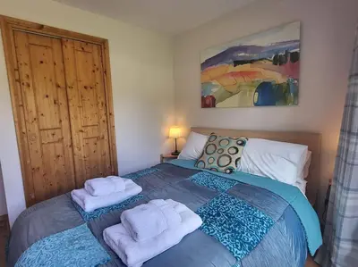 a bedroom with a bed with towels on it at A1/2, 3 bedroom apartment next to the ski lift in Samoëns