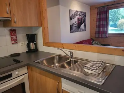 a kitchen with a sink and a counter top at A1/2, 3 bedroom apartment next to the ski lift in Samoëns
