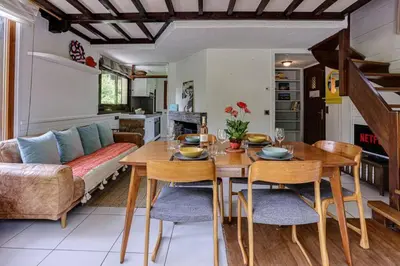 a living room with a table and a couch at chalet l'ilet ensoleillé /Sunny Island Chalet in Chamonix-Mont-Blanc