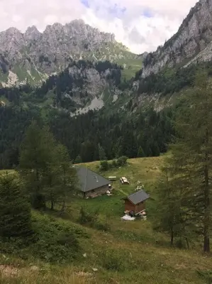 a small house on a hill with a mountain at chalet l'ilet ensoleillé /Sunny Island Chalet in Chamonix-Mont-Blanc