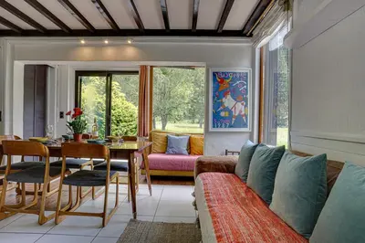 a living room with a couch and a table at chalet l'ilet ensoleillé /Sunny Island Chalet in Chamonix-Mont-Blanc