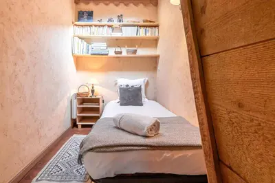 a small bedroom with a bed in a small room at Les Cristalliers - Cozy family chalet - Close to the village in Les Houches