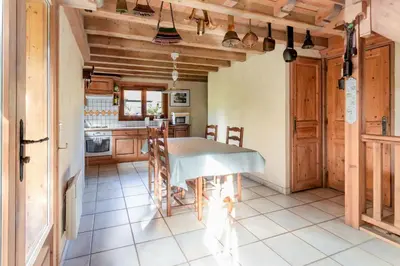 a kitchen with a table in the middle of a room at Les Cristalliers - Cozy family chalet - Close to the village in Les Houches