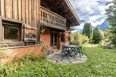 a table and chairs sitting outside of a house at Les Cristalliers - Cozy family chalet - Close to the village in Les Houches