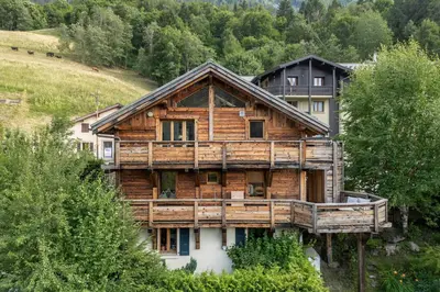 a wooden house on a hill with trees at AO HOUSE - PRAKKA Base Camp in Les Houches