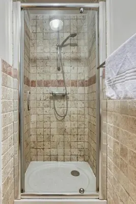 a shower with a shower head in a bathroom at AO HOUSE - PRAKKA Base Camp in Les Houches