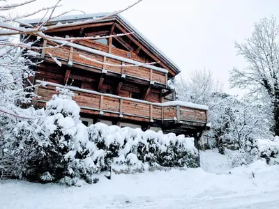 a log cabin covered in snow in front of it at AO HOUSE - PRAKKA Base Camp in Les Houches