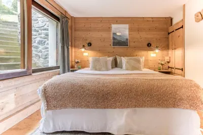 a bedroom with a large bed and a window at AO HOUSE - PRAKKA Base Camp in Les Houches