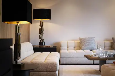 a living room with two couches and a tv at L'Ecrin Blanc Megève in Megève