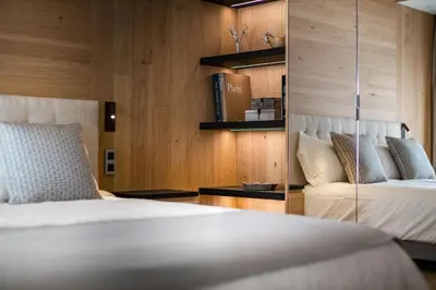 a bedroom with a bed and a book shelf at L'Ecrin Blanc Megève in Megève
