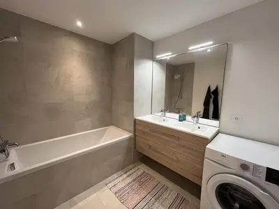 a bathroom with a tub sink and a washing machine at Superbe appart 3P au pied des pistes, parking couvert, terrasse, WiFi - Les Carroz - FR-1-572-288 in Arâches-la-Frasse