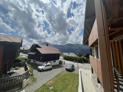 a view of a house with a car parked in a parking lot at Superbe appart 3P au pied des pistes, parking couvert, terrasse, WiFi - Les Carroz - FR-1-572-288 in Arâches-la-Frasse