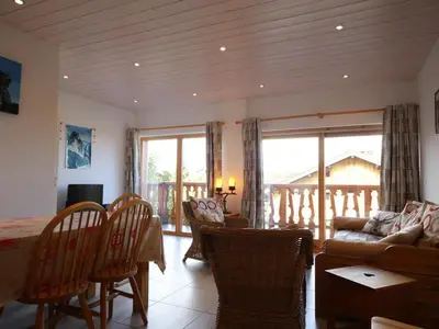 a living room with a couch and a table and chairs at Appartement 3 pièces - 6 pers - Proche pistes et commerces, navette gratuite - FR-1-572-19 in Arâches-la-Frasse