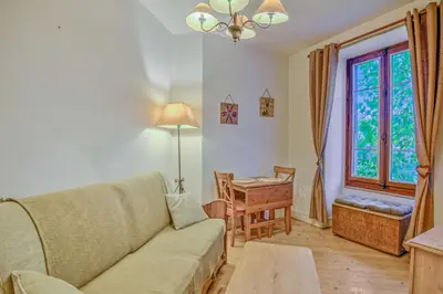 a living room with a couch and a table and a window at Appartement Yodel - Welkeys in Saint-Gervais-les-Bains